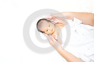 Cute newborn baby girl in white blanket onÂ nurseryÂ bed.Â AdorableÂ new born child, little boy eyes look people Family, new